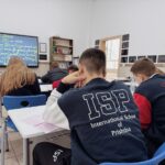 Students attentively learning in a classroom at the International School of Prishtina.